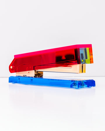 side view of colorblock stapler with pinkish red top and blue bottom