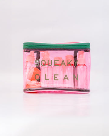 pink and green plastic 'squeaky clean' travel kit with two pots, a funnel, mini spatula, one pump, one spray bottle and label sheet