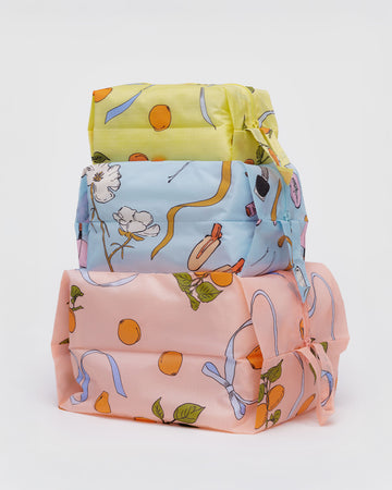 set of three 3D zip pouches: small yellow apricot ribbon, light blue get ready with me, and large light pink apricot ribbon
