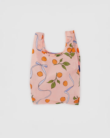 light pink baby baggu with lavender bow ribbons and apricot print