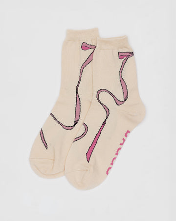 cream socks with pink bows on the back with flowing ribbon to the front