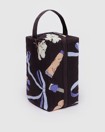 chocolate plum dopp kit with makeup, ribbon, and floral print