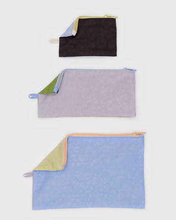 set of three flat pouch set with double sided colorways: small french blue/chocolate plum, medium dusty pink/green juice, and large french blue/butter