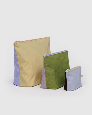 set of three go pouch set with double sided colorways: small french blue/chocolate plum, medium dusty pink/green juice, and large french blue/butter