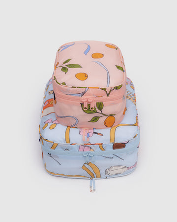 set of two packing cubes: small pink apricot and ribbon print and large light blue get ready with me print