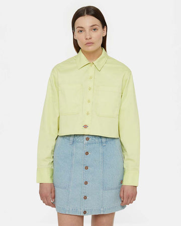 model wearing cropped pale green button up top woth collar and extended front patch pockets