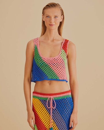 model wearing open crochet cropped tank with diagonal rainbow stripes and matching skirt