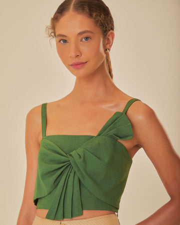 model wearing green cropped tank with oversized bow detail on the bust