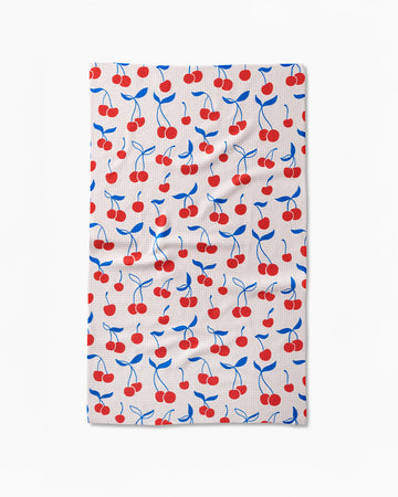 white tea towel with red and blue cherry print