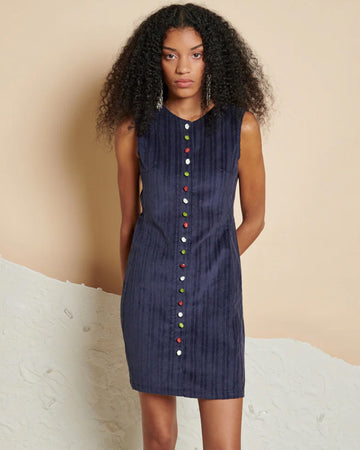 model wearing blue corduroy mini dress with colorful button front