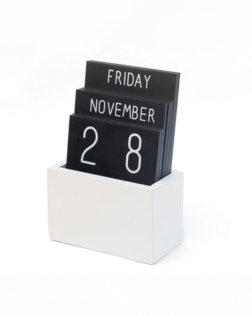 black day, month and day tiles in a white box stand