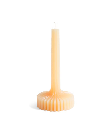 beige taper candle with fanned round base