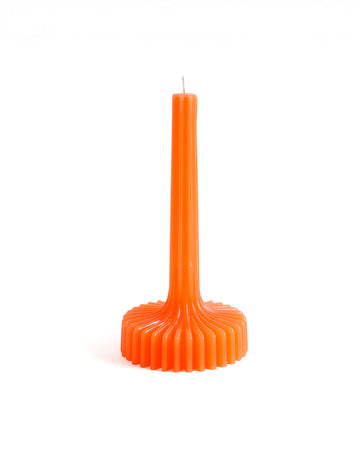 orange taper candle with fanned round base