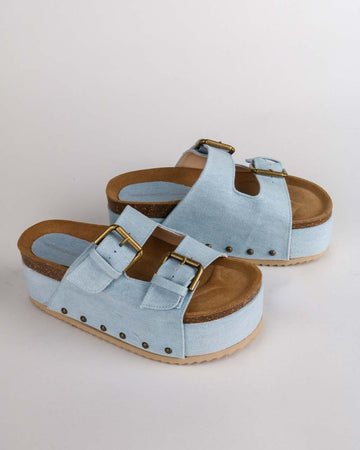 light denim platform slide sandal with brass buckles