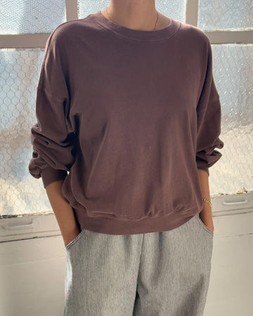 model wearing espresso cali jersey sweatshirt with banded sleeves and bottom hem
