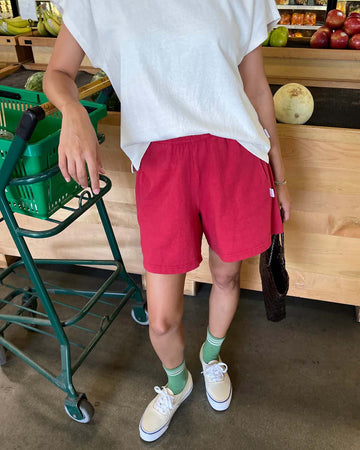 model wearing crayon red colored cotton shorts