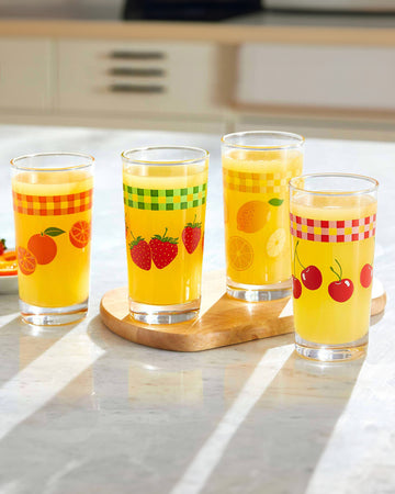 set of 4 vintage inspired fruit glasses: cherry, orange, strawberries and lemon filled with orange beverage