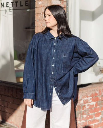 model wearing oversized button dark denim front top with front patch pocket