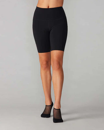 model wearing black biker shorts with side pockets