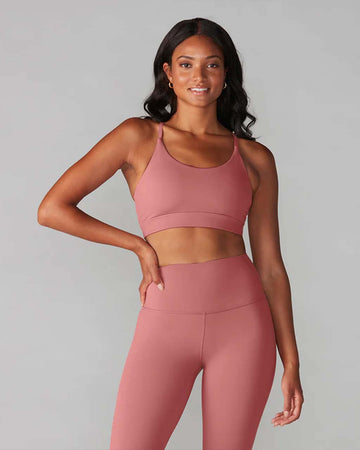 model wearing dark mauve sports bra