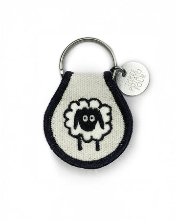 cream patch keychain with sheep print with black trim
