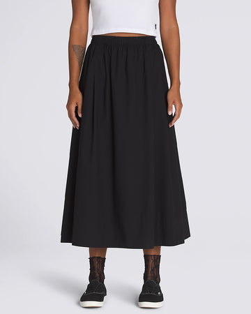 model wearing flowy black midi skirt