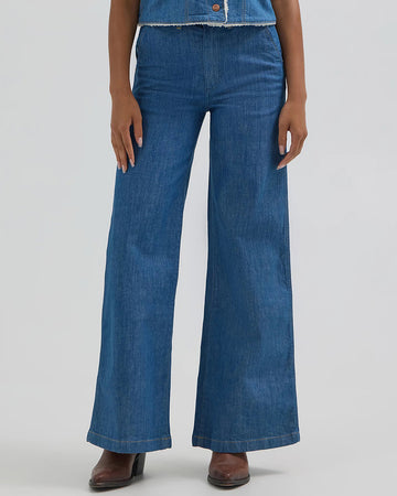 model wearing medium denim with a wide flare leg