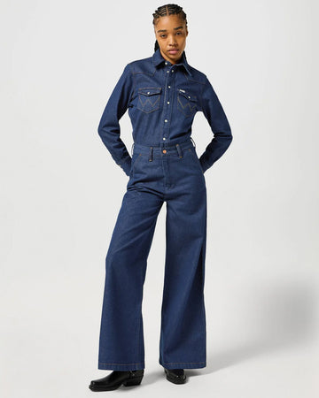 model wearing dark blue trouser coverall with front patch pockets, button front and button waist