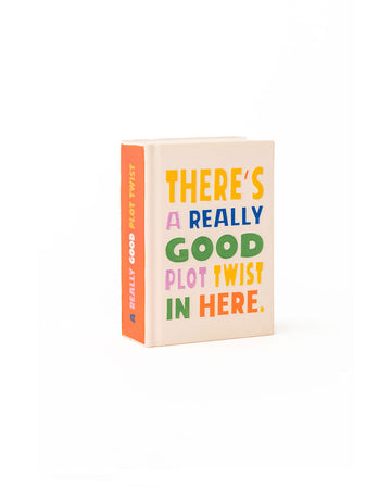 book shaped de-stress ball with 'there's a really good plot twist in here' on the front and spine