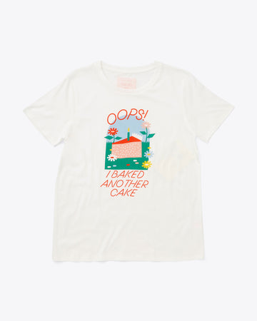 ivory t-shirt with whimsical cake illustration and "OOPS! I BAKED ANOTHER CAKE" text graphic in red