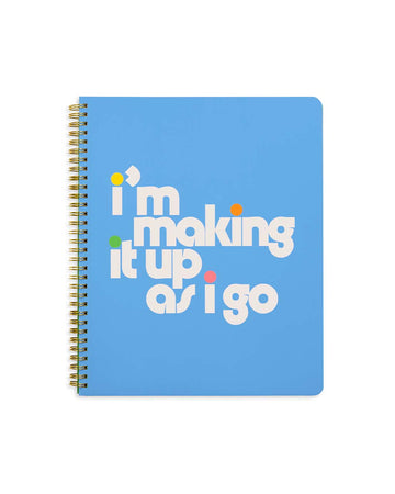 blue large notebook with white 'i'm making it up as i go' across the front