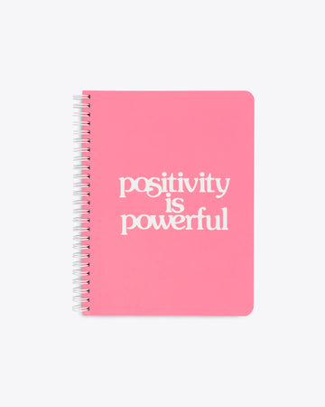 bright pink notebook with the words positivity is powerful on the cover