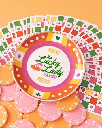 poker chip trinket tray with colorful print with 'the lucky lady casino $500' across the front surrounded by poker chips and playing cards