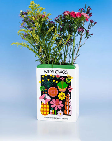 ceramic vase in the shape of wildflowers seed packet with flowers inside