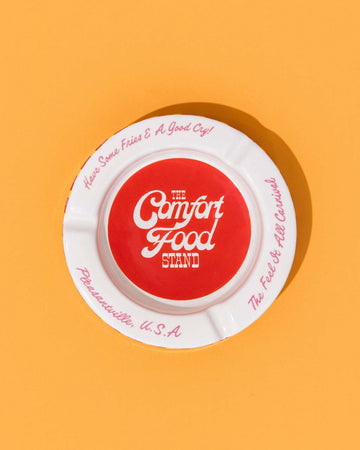 Red and white circular trinket tray on a yellow background